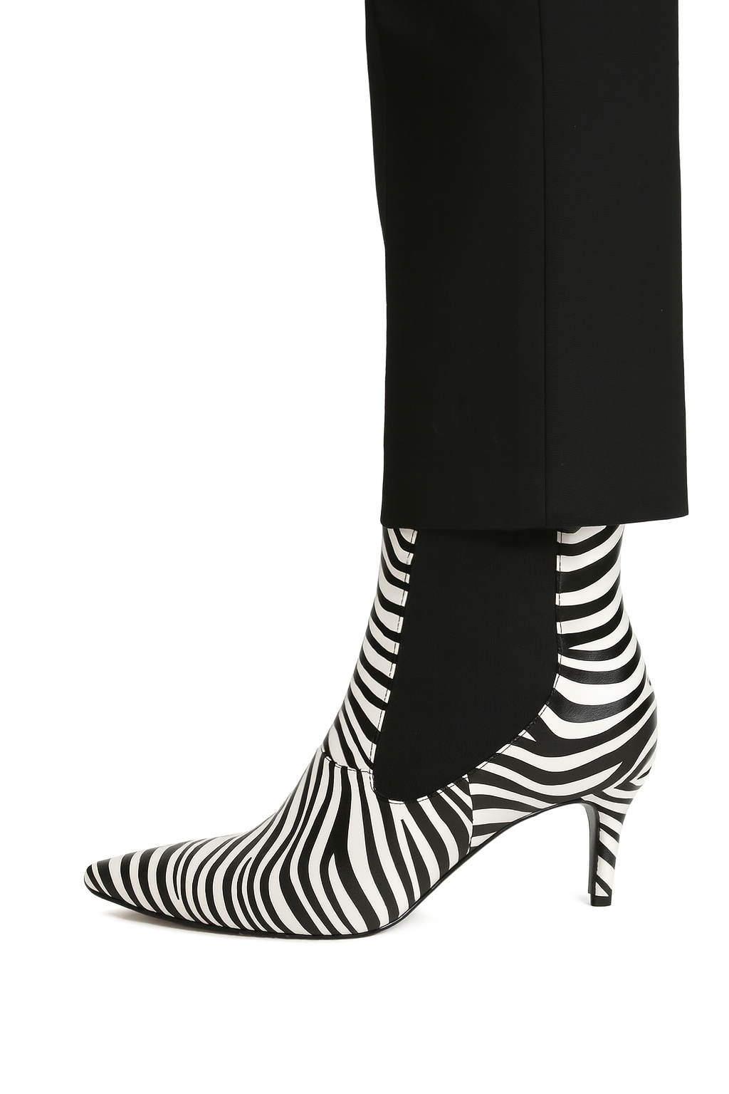 Black and white striped high-heeled boots worn with black pants on a white background